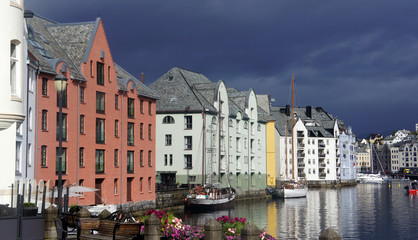 Alesund, Norway - Picturesque view of colorful buildings in norwegian town before rain, beautiful old city centre