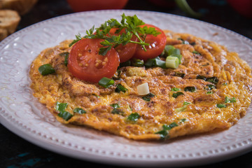 Omelet, fried chicken eggs with fresh vegetables