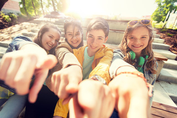 friendship, gesture and people concept - happy teenage friends or high school students pointing finger at you