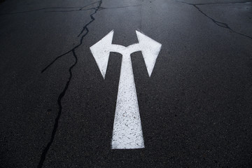 Dark asphalt City asphalt road with two way arrow sign background.with two way arrow sign