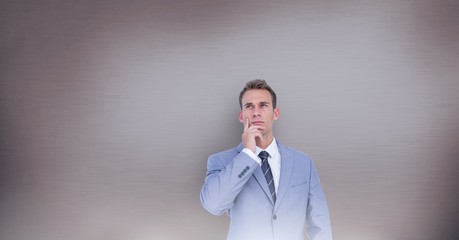 Woman thinking in front of wall