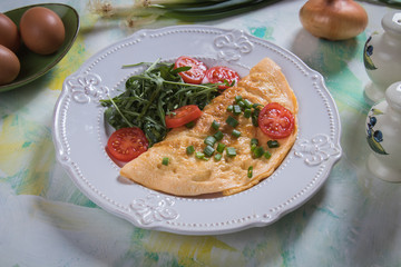 Omelet, fried chicken eggs with fresh vegetables