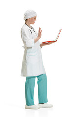 Beautiful young woman in white coat posing at studio. Full length studio shot isolated on white.