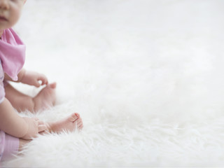 baby feet on white blanket. copy space. selective focus