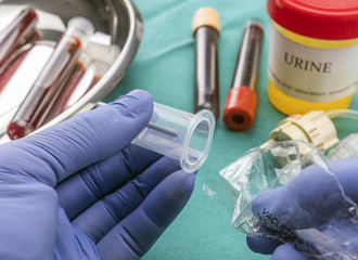 Doctor holds blood sample at a hospital table, conceptual image