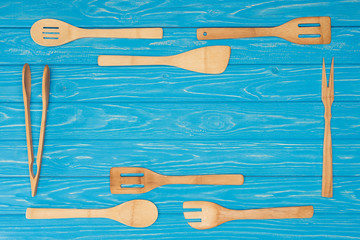 top view of set of kitchen utensils on blue wooden table