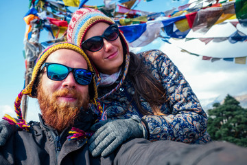 A beautiful and active woman and a bearded man do selfie in trekking in the mountains. the concept...