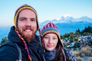 A beautiful and active woman and a bearded man do selfie in trekking in the mountains. the concept...