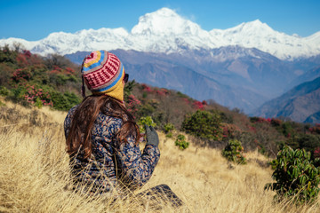 Smiling young beautiful and active woman in trekking in the mountains. the concept of active recreation and tourism in the mountains. trekking in Nepal Himalayas