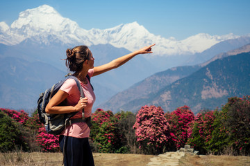 Smiling young beautiful and active woman in trekking in the mountains. the concept of active recreation and tourism in the mountains. trekking in Nepal Himalayas