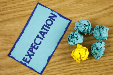 Word writing text Expectation. Business concept for Meteorological research analyst predicts weather forecast written on Sticky Note paper on wooden background Paper Balls next to it.