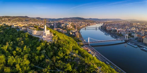Deurstickers Budapest, Hungary - Aerial panoramic skyline view of Budapest at sunrise. This view includes the Statue of Liberty, Elisabeth Bridge, Buda Castle Royal Palace and Szechenyi Chain Bridge with blue sky © zgphotography