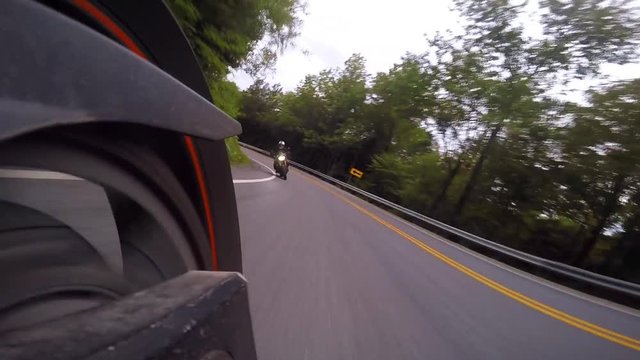 motorcycles through tight corners in mountains low swingarm reverse cam has an amazing angle