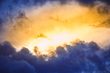 Background of colorful dramatic clouds in the dark sky before a thunderstorm.