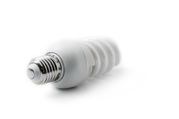 Energy saving fluorescent spiral light bulb on white background. Diagonal view. Shallow depth of...
