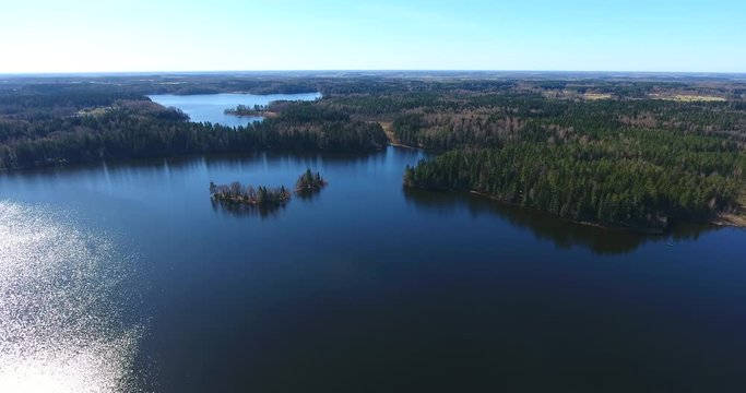 Aerial view of the beautiful Plateliai lake with islands, forest, blue water and clear sky - 6