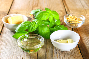 Ingredients for pesto sauce. Cheese, garlic, basil, pine nuts, olive oil.