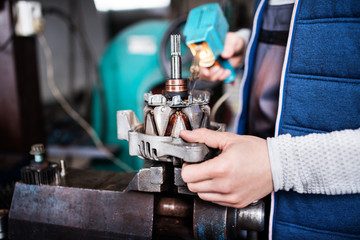 Man mechanic repairing a car in a garage.