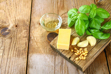 Ingredients for pesto sauce. Cheese, garlic, basil, pine nuts, olive oil.