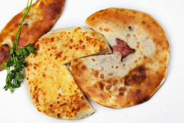 The Georgian homemade bread, lavash, khachapuri on the white table. Isolated photo.