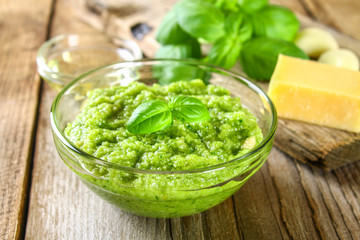 Homemade pesto sauce. Ingredients. Cheese, garlic, basil, pine nuts, olive oil on an old wooden table.