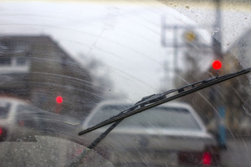 Windshield wipers from inside of car, season rain.