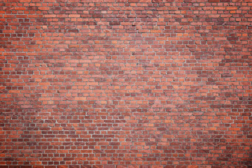 Big full frame background of detailed old red brick wall with vignette. Copy space.