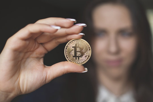 Successfully woman holds a Bitcoin. Crypto coin. Blockchain