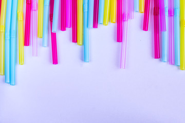 vibrant background of multicolored plastic straws, copy space