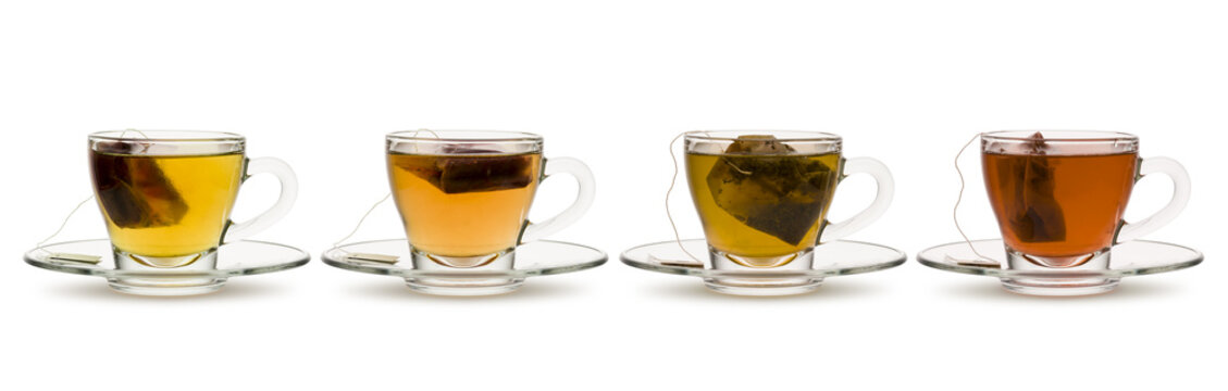 variety of tea and herbal teas in glass cups with tea bag inside, on white background