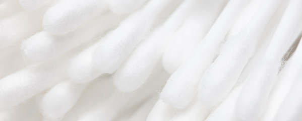 White eared cotton swabs as a background