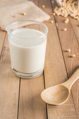 Soy milk and beans on wooden table background