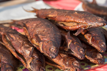 Smoked fish are sold on the market counter on the street
