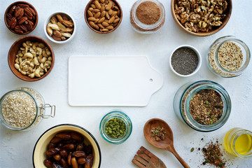 Cocoa granola and ingredients. Healthy breakfast. Concrete white background. Top view
