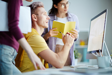 Group of designers working on project together at office