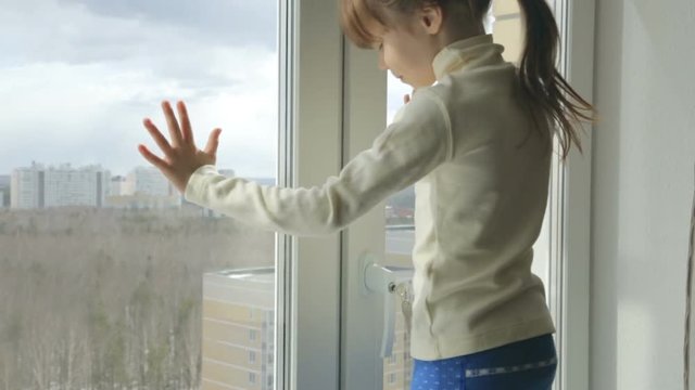 Little girl on the windowsill