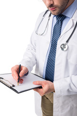 Close-up view of doctor wearing white coat with stethoscope and writing in clipboard isolated on white