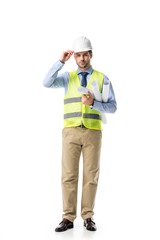 Young man in reflective vest and hard hat holding blueprints isolated on white