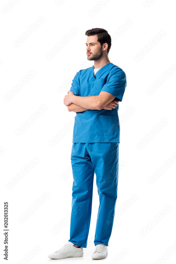 Wall mural handsome male nurse wearing blue uniform isolated on white