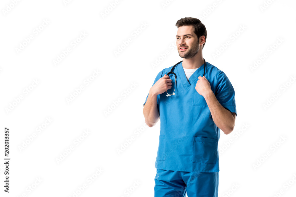 Wall mural Young male nurse wearing blue uniform with stethoscope isolated on white