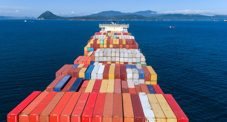 Top view of a laden container ship on a sunny afternoon.