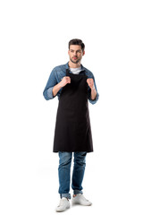 young bearded waiter in apron looking away isolated on white