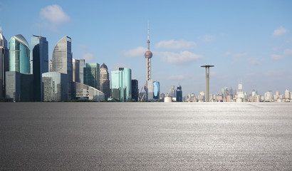 Empty road surface floor with city landmark buildings of Shanghai Skyline