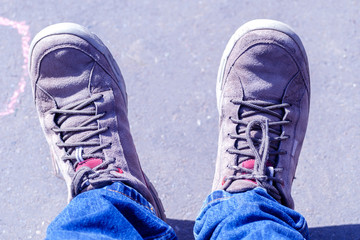 men's legs in blue jeans and sneakers