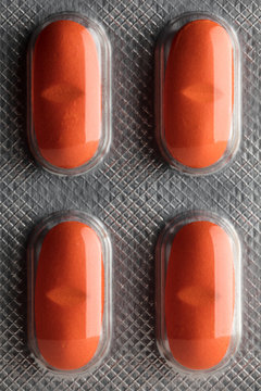 Top view of orange pills in package