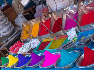 Indian rangoli powder, incense and joss sticks on display in a market. They are used in Hindu forehead marking and for festivals, as well as dying and making patterns at entrances to homes and rooms