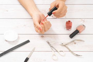 Women's hands with tools for manicure. Nail care.