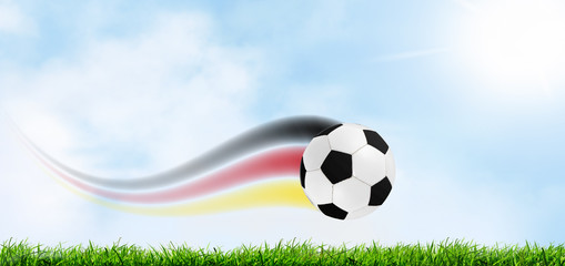 fliegender fußball mit deutsche flagge.