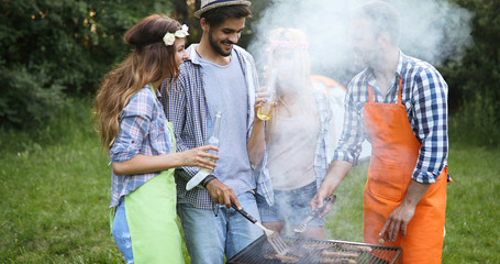 Friends having a barbecue party in nature