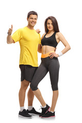 Fitness couple making a thumb up gesture